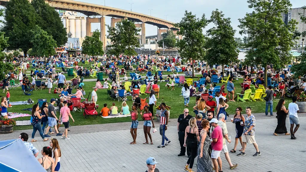 Colorful crowd canalside lawn
